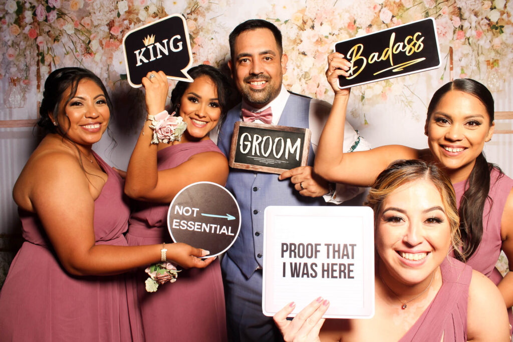 Wedding guests posing with signs at San Antonio photo booth