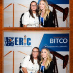 Corporate event attendees creating memories with a branded photo booth.