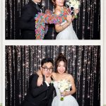Bride and groom celebrating with family in the Peek A Booth photo booth at Canyon Springs Golf Club.