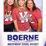 Boerne Education Foundation guests posing at a photo booth in Boerne, Texas.