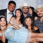 Quinceañera guests posing for photos at a custom photo booth in Seguin, Texas.