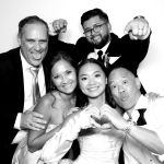 Wedding guests enjoying a custom photo booth at Alyssa and Ryan's wedding at Gardens of Cranesbury View in New Braunfels, Texas.