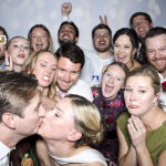 Wedding guests enjoying a custom photo booth at the Uries' wedding at the San Antonio Zoo in Texas.